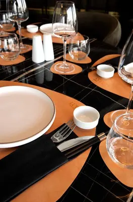 a table with plates and wine glasses on it at Luwian Athens Boutique Hotel in Athens