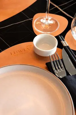 a table with plates and utensils on a table at Luwian Athens Boutique Hotel in Athens