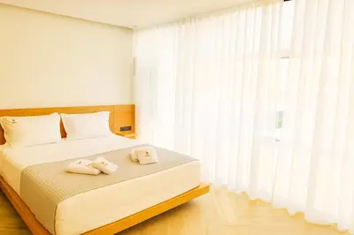 a bedroom with a bed with two towels on it at Triple A - Chic & Elegant by the Market - FREE parking! in Athens