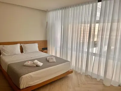 a bedroom with a bed with two towels on it at Triple A - Chic & Elegant by the Market - FREE parking! in Athens