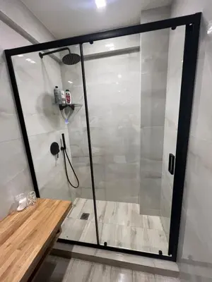 a shower with a glass door in a bathroom at Triple A - Chic & Elegant by the Market - FREE parking! in Athens