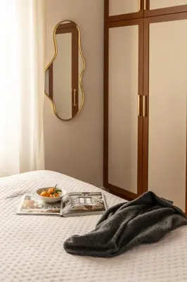 a plate of fruit on a bed with a mirror at Kolonaki Chic Haven - A Downtown Retreat in Athens