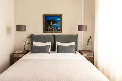 a bedroom with a large bed with two night stands at Kolonaki Chic Haven - A Downtown Retreat in Athens