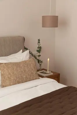 a bedroom with a bed with a candle on a table at Kolonaki Chic Haven - A Downtown Retreat in Athens
