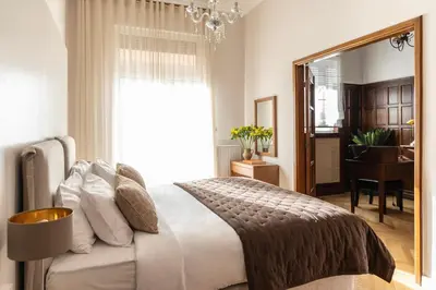 a bedroom with a large bed and a mirror at Kolonaki Chic Haven - A Downtown Retreat in Athens