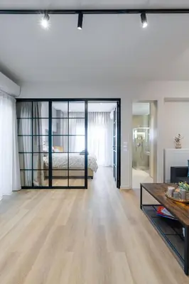 a living room with a bed and a table at Alkis Luxury By Greece Apartments in Athens