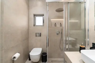 a bathroom with a shower with a toilet and a sink at Alkis Luxury By Greece Apartments in Athens