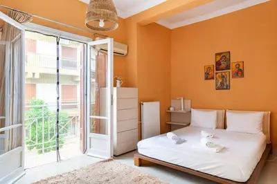 a bedroom with a bed and a large window at Apartment with terrace in Piraiki in Piraeus
