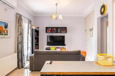 a living room with a couch and a table at Apartment with terrace in Piraiki in Piraeus