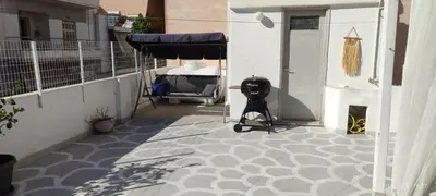 a balcony with a table and a bed on a building at Apartment with terrace in Piraiki in Piraeus