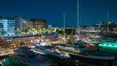 a group of boats docked at a marina at night at Apartment with terrace in Piraiki in Piraeus