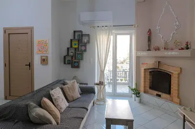 a living room with a couch and a fireplace at Private Spacious Apartment in Athens