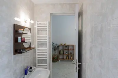 a bathroom with a sink and a mirror at Private Spacious Apartment in Athens