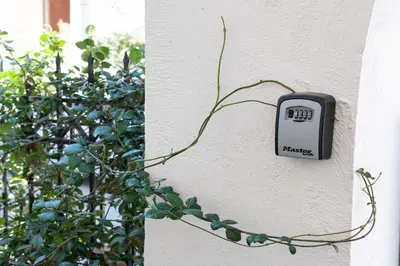a thermostat on the side of a wall with a plant at Private Spacious Apartment in Athens