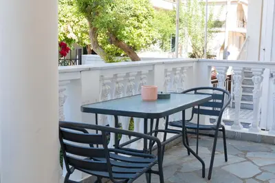a blue table and chairs on a balcony at Private Spacious Apartment in Athens