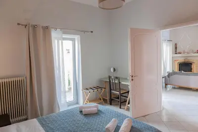 a white room with a bed and a fireplace at Private Spacious Apartment in Athens