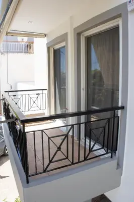 a balcony with a black railing and a window at Cozy flat in Elliniko - 300Mbps Wi-Fi in Athens