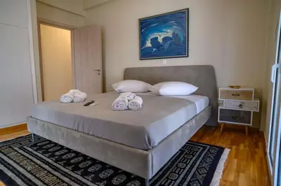a bedroom with a large bed with towels on it at Luxury Modern 2 bed Elegance in Athens