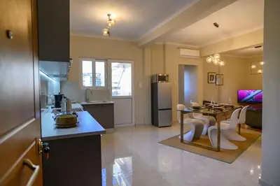 a kitchen and living room with a table and a dining room at Luxury Modern 2 bed Elegance in Athens