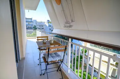 a balcony with a table and chairs on it at Luxury Modern 2 bed Elegance in Athens