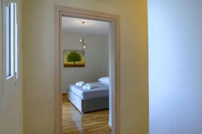 a hallway with a mirror and a bed in a room at Luxury Modern 2 bed Elegance in Athens