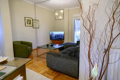 a living room with a couch and a tv at Luxury Modern 2 bed Elegance in Athens
