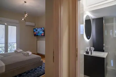 a bedroom with a bed and a sink and a mirror at Luxury Modern 2 bed Elegance in Athens