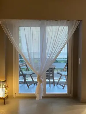 a large window with a view of a deck at Miliannas in Athens