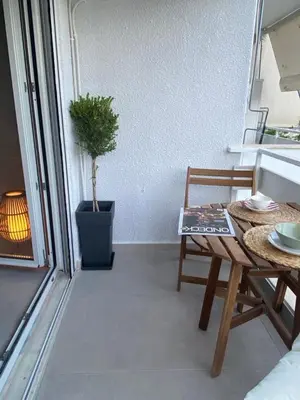 a room with a table and a chair on a balcony at Miliannas in Athens
