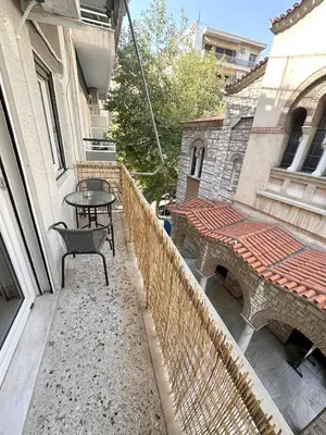a balcony of a building with a table and a table gmaxwell gmaxwell gmaxwell at Check Point - Athens Heart in Athens