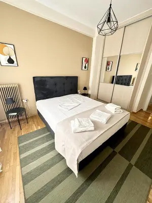 a bedroom with a large bed with two pillows on it at Check Point - Athens Heart in Athens