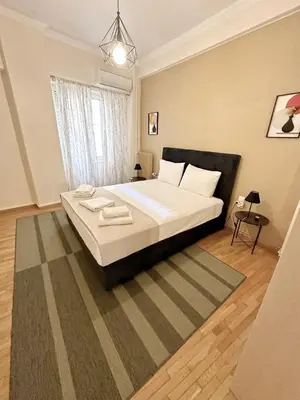 a bedroom with a large bed in a room at Check Point - Athens Heart in Athens