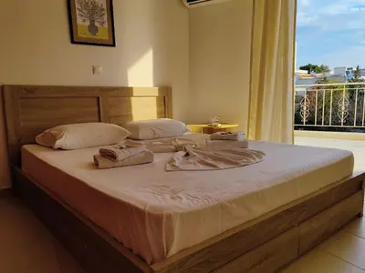 a bed with towels on it in a room with a window at Finikas Spata Holiday Apartment in Spáta