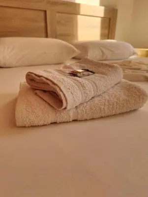 a towel is sitting on top of a bed at Finikas Spata Holiday Apartment in Spáta