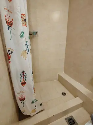a bathroom with a shower with a shower curtain at Finikas Spata Holiday Apartment in Spáta