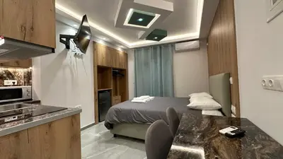 a small room with a bed and a kitchen at Luxury Semi Basement Apartment with Terrace in Athens