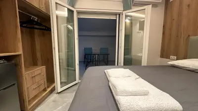 a bedroom with a bed and a sliding glass door at Luxury Semi Basement Apartment with Terrace in Athens