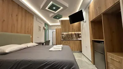 a bedroom with a large bed with a television on it at Luxury Semi Basement Apartment with Terrace in Athens