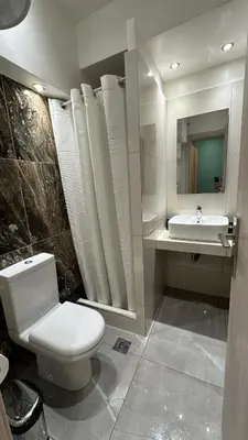 a bathroom with a white toilet and a sink at Luxury Semi Basement Apartment with Terrace in Athens