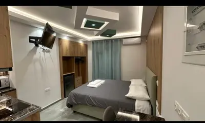 a small room with a bed in a room at Luxury Semi Basement Apartment with Terrace in Athens