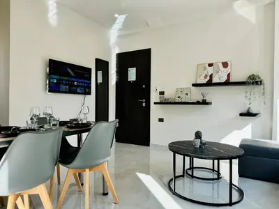 a living room with a table and chairs and a couch at Kozy Koala Apartments n22 in Athens