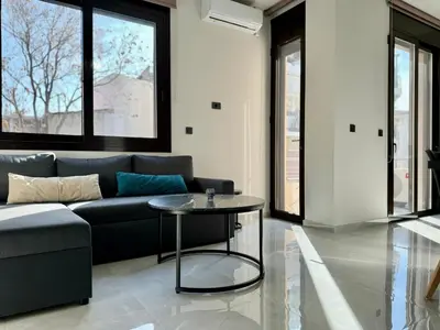 a living room with a couch and a table at Kozy Koala Apartments n22 in Athens