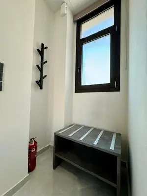a bench in the corner of a room with a window at Kozy Koala Apartments n22 in Athens