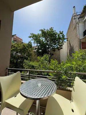 a patio with a table and chairs on a balcony at Kozy Koala Apartments n22 in Athens