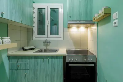a kitchen with a sink and a stove top oven at Olive House close to Acropolis in Athens
