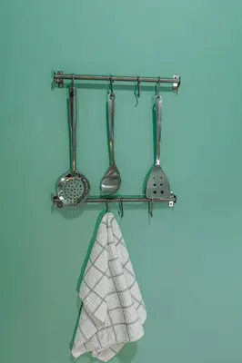 a rack with utensils and a towel at Olive House close to Acropolis in Athens