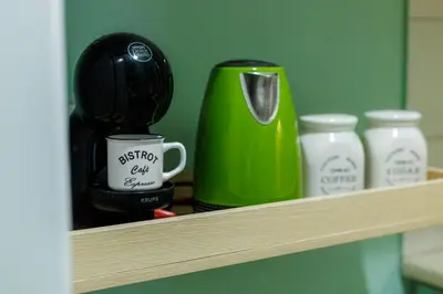 a shelf with a green coffee maker and other items at Olive House close to Acropolis in Athens