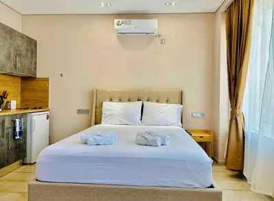 a bedroom with a bed with two towels on it at Port Twins Suites No2 in Piraeus