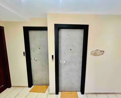 two doors in a room with a rock on the wall at Port Twins Suites No2 in Piraeus