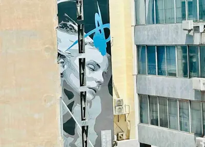 a mural of a face on the side of a building at Port Twins Suites No2 in Piraeus